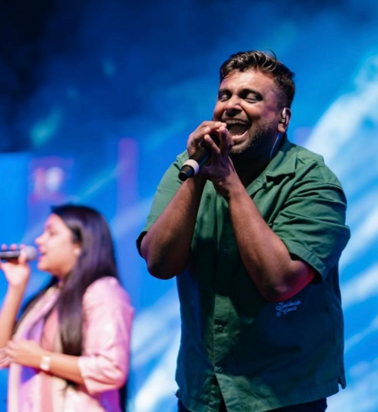 Selvam worship performance with blue stage lighting